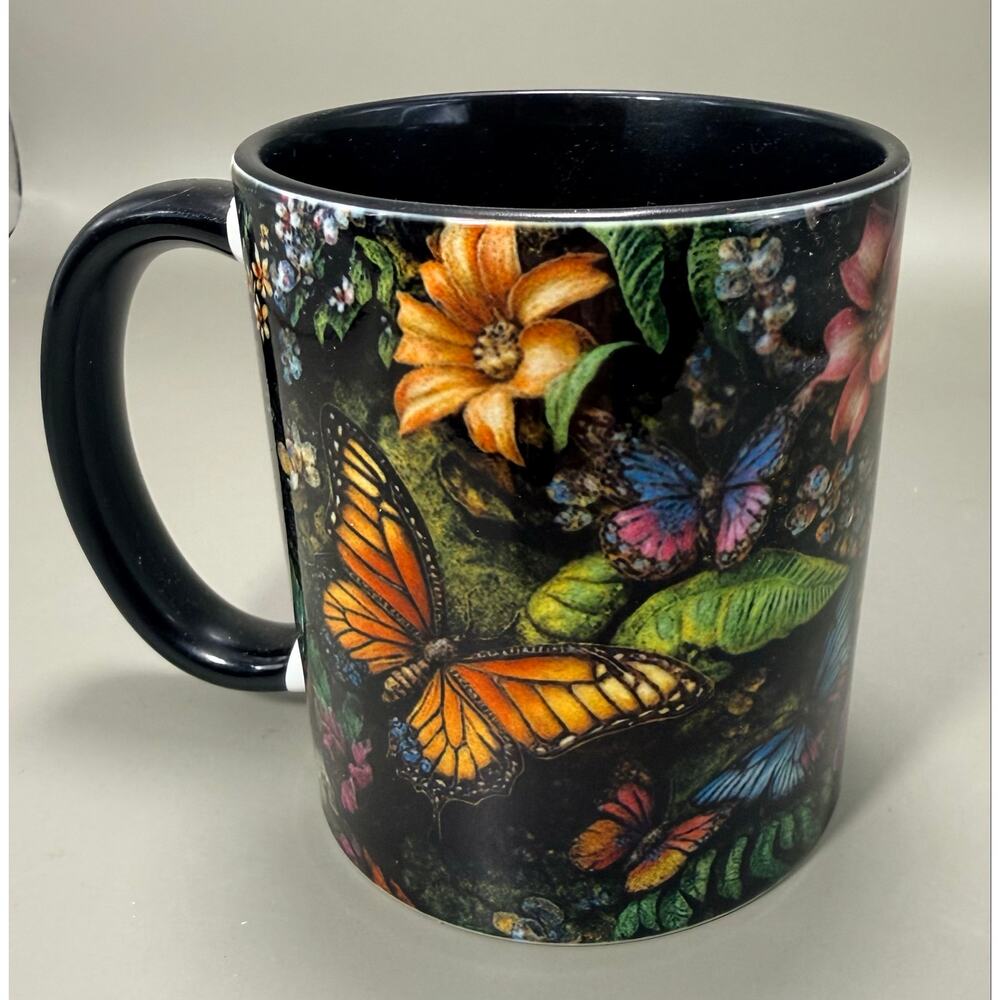 glossy black ceramic mug with a vibrant design of monarch butterflies floral art
